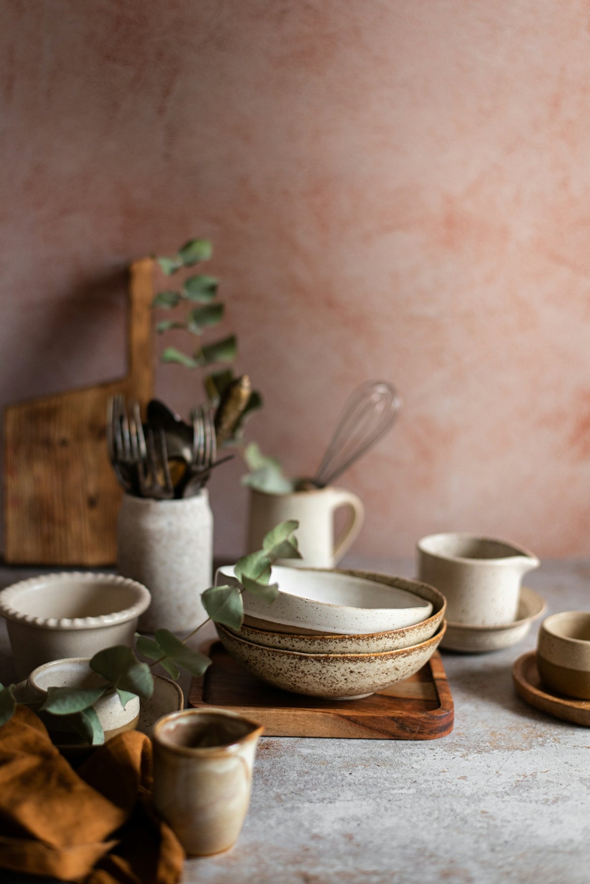 Various ceramic bowls and kitchen utensils arranged decoratively